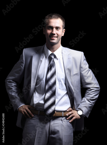 Young businessman standing against isolated white background