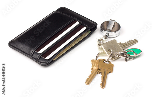 black leather wallet and bunch of keys over white