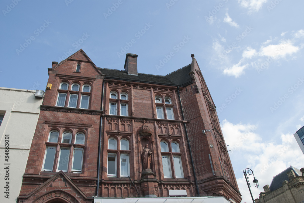 Victorian Red Brick Offices with a statue carving Victorian Red Brick Offices with a statue carving