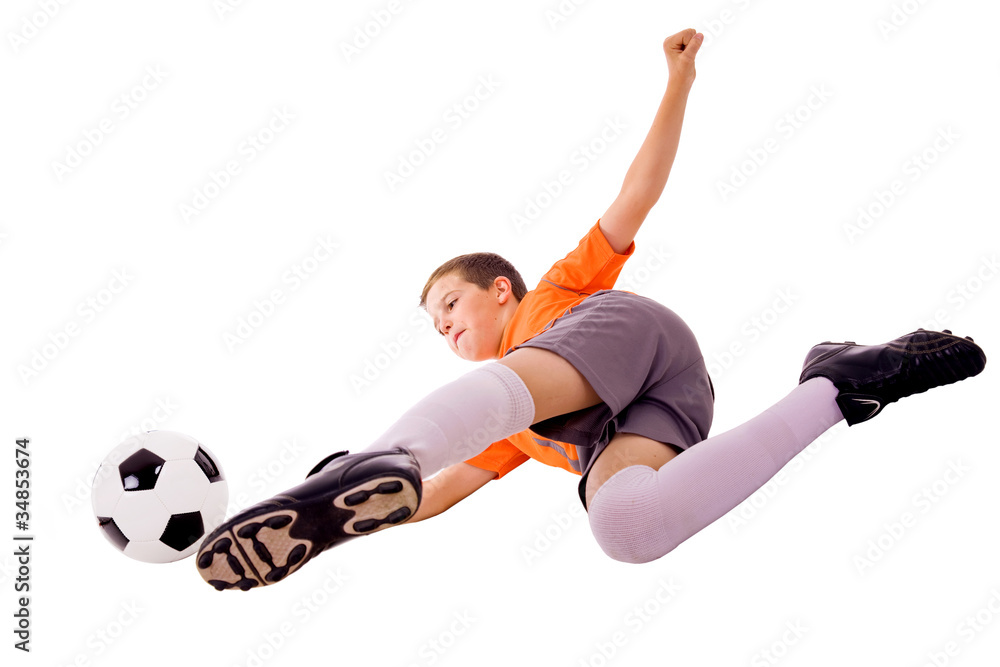 Young boy with soccer ball doing flying kick, isolated on white Young boy with soccer ball doing flying kick, isolated on white