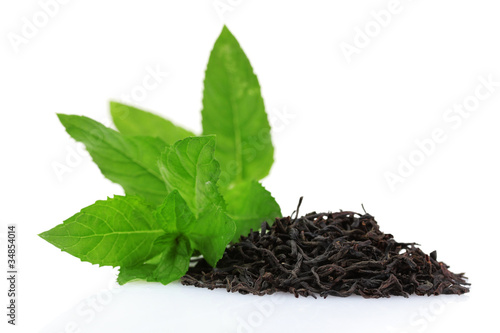 dry black tea leaves and mint isolated on white