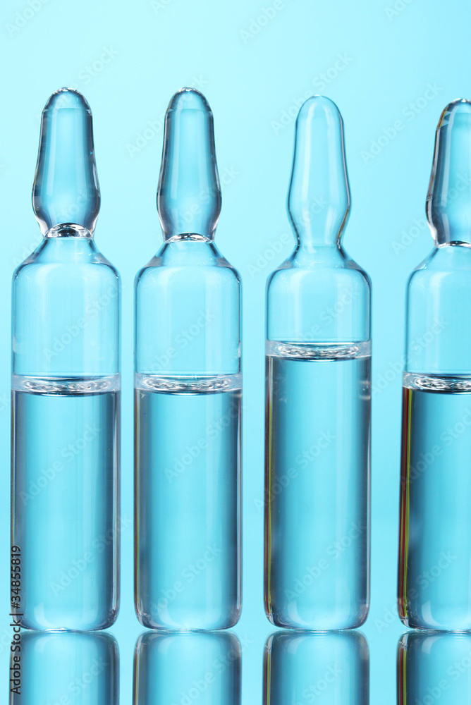 medical ampoules on blue background medical ampoules on blue background