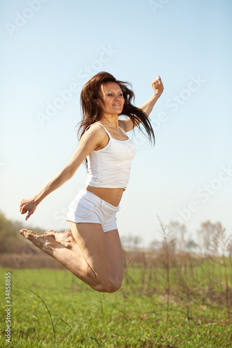Jumping mid adult woman
