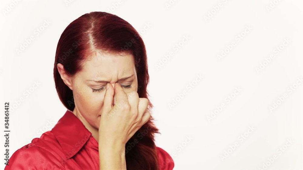 Woman with headache pinching bridge of her nose Woman with headache pinching bridge of her nose