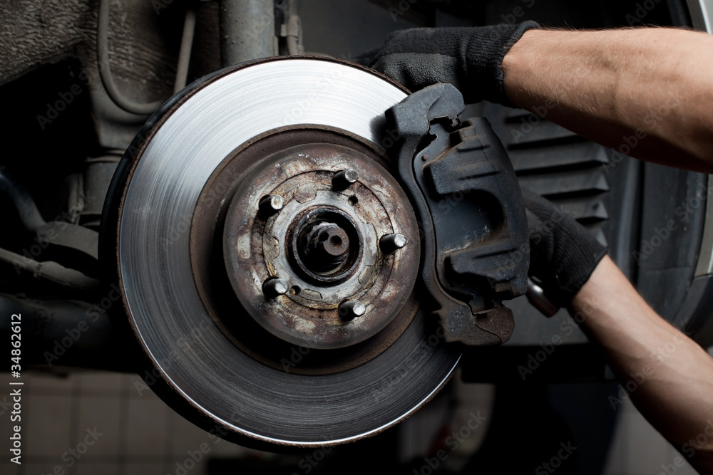 Fototapeta premium Car mechanic repair brake pads