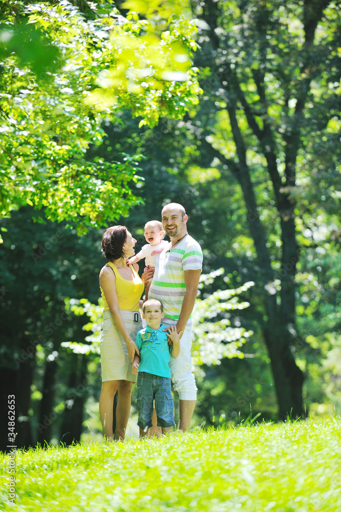 happy young couple with their children have fun at park happy young couple with their children have fun at park