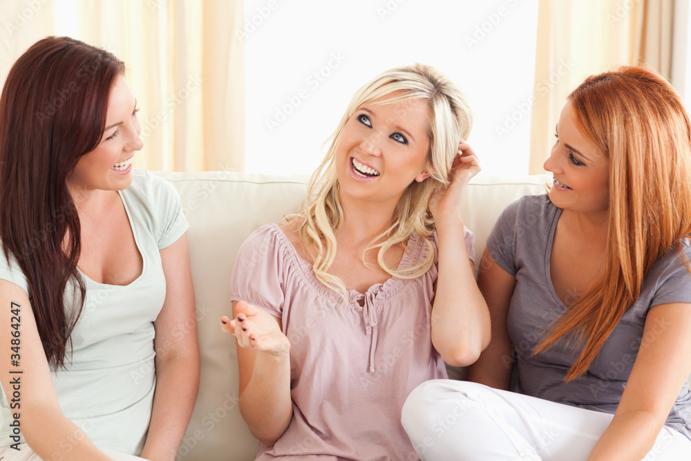Joyful friends sitting on a sofa Joyful friends sitting on a sofa