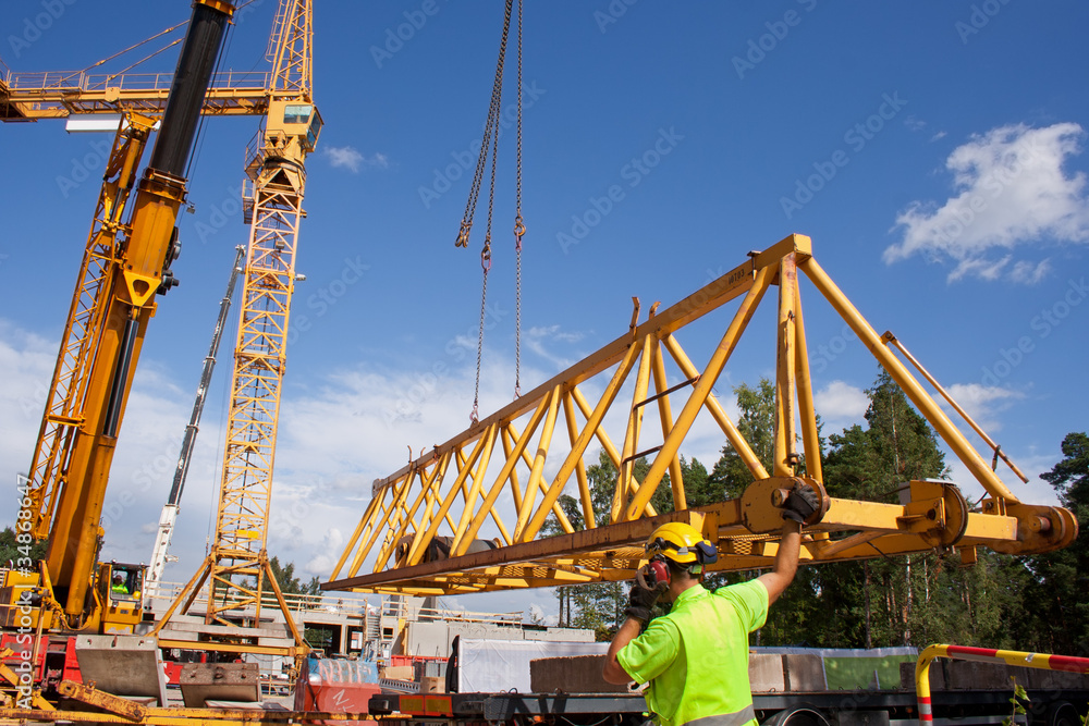 Setting up a tower crane in the construction site.