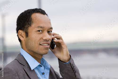 Suited male outside with mobile