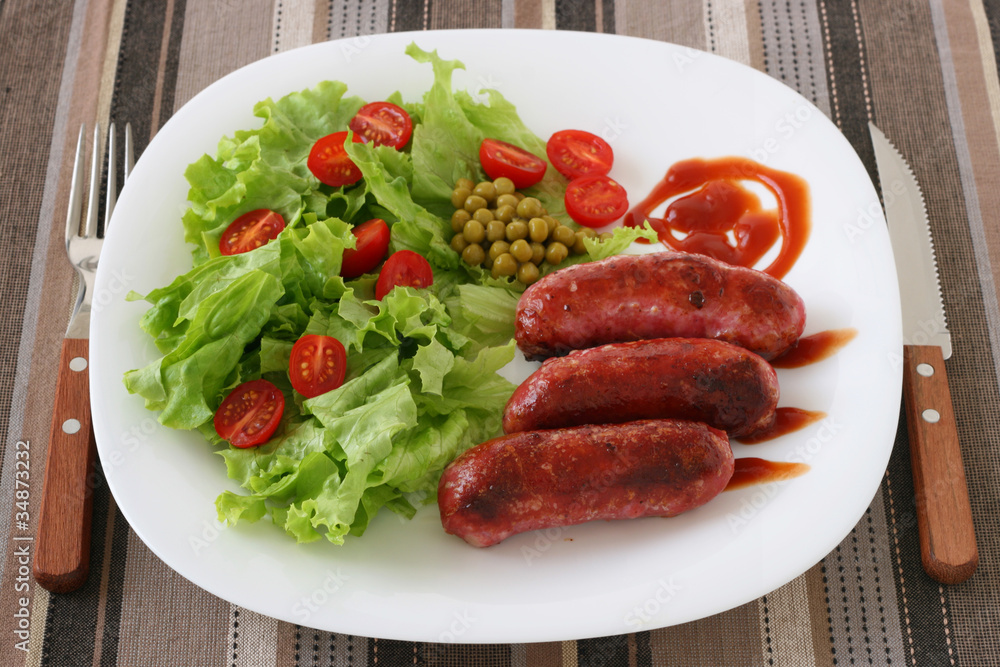 Fried sausages with salad