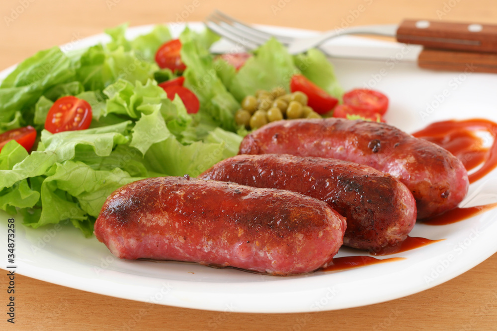 Fried sausages with salad