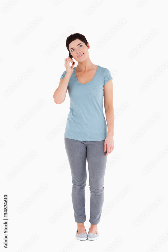 Dark-haired woman answering the phone Dark-haired woman answering the phone