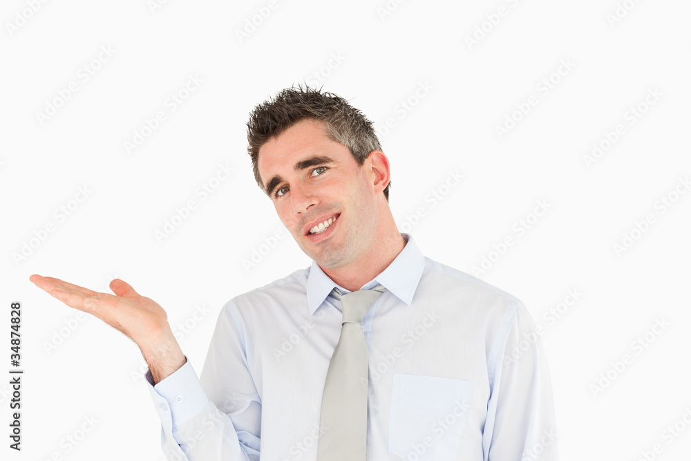 Smiling businessman showing a copy space Smiling businessman showing a copy space
