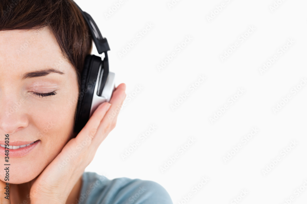 Close up of a delighted woman enjoying some music Close up of a delighted woman enjoying some music