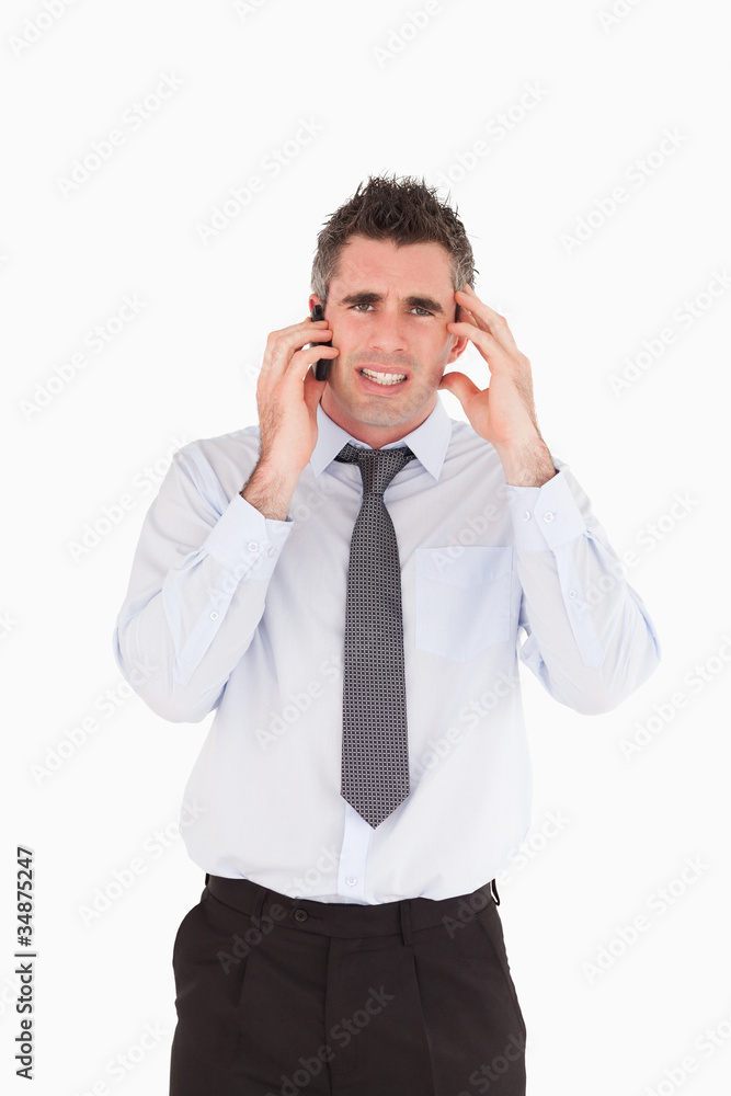 Portrait of an upset man making a phone call Portrait of an upset man making a phone call