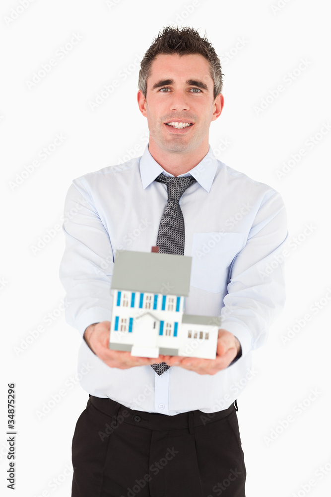 Real estate agent holding a miniature house Real estate agent holding a miniature house