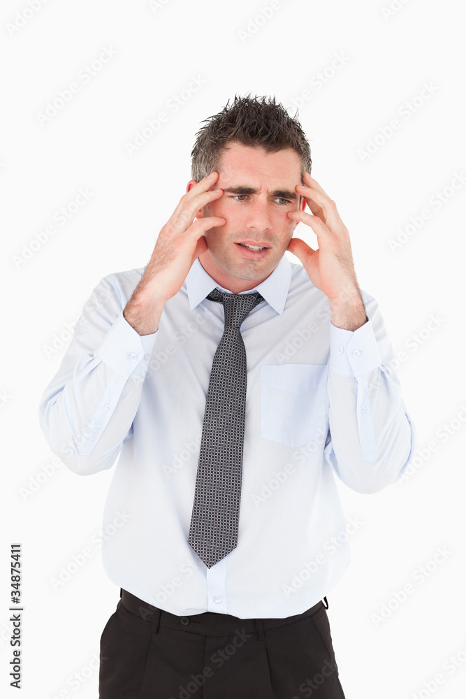 Portrait of a sad businessman with his hands on his temples Portrait of a sad businessman with his hands on his temples