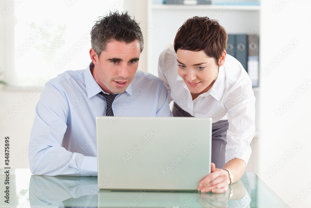 Coworker working with a laptop Coworker working with a laptop