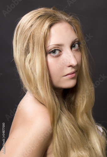 Portrait of young beautiful girl with fair long hair