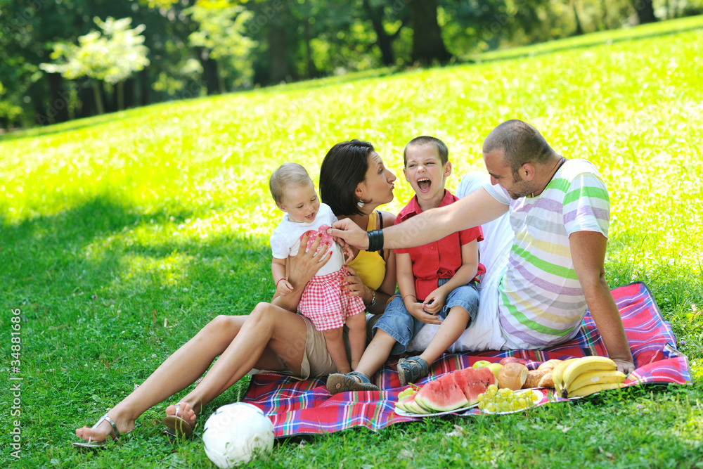 happy young couple with their children have fun at park happy young couple with their children have fun at park