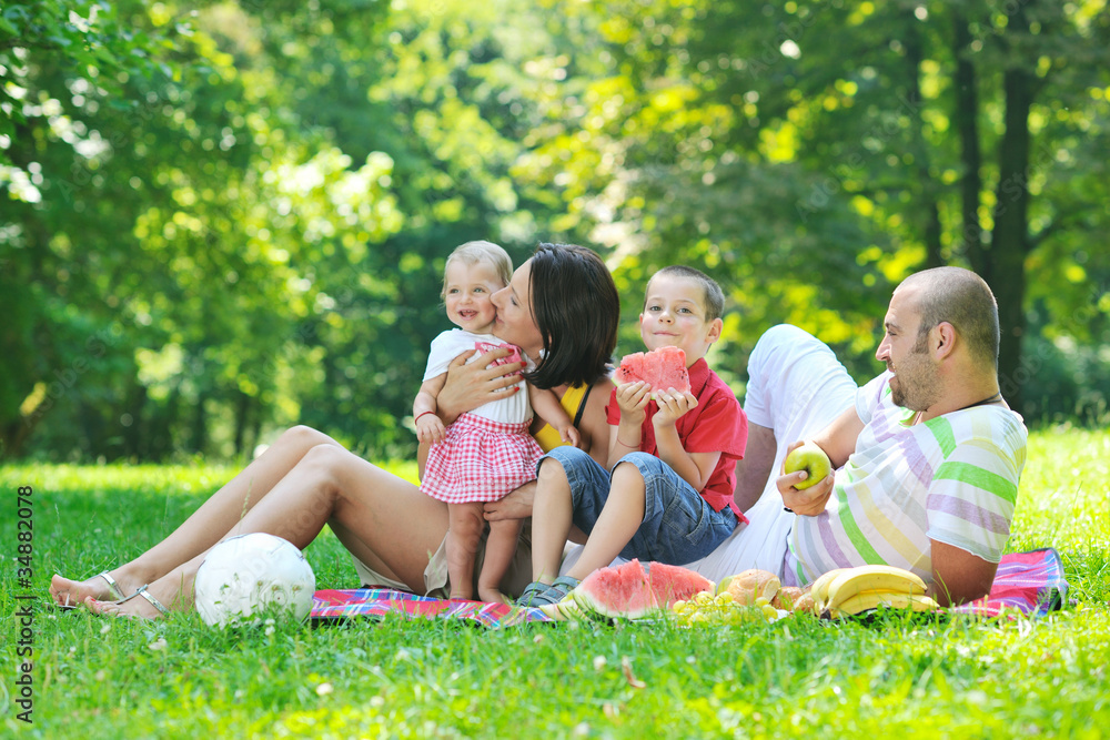 happy young couple with their children have fun at park happy young couple with their children have fun at park