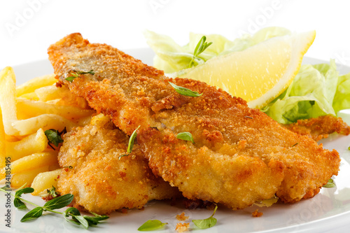 Canvas Print Fish dish - fried fish fillet, French fries with vegetables