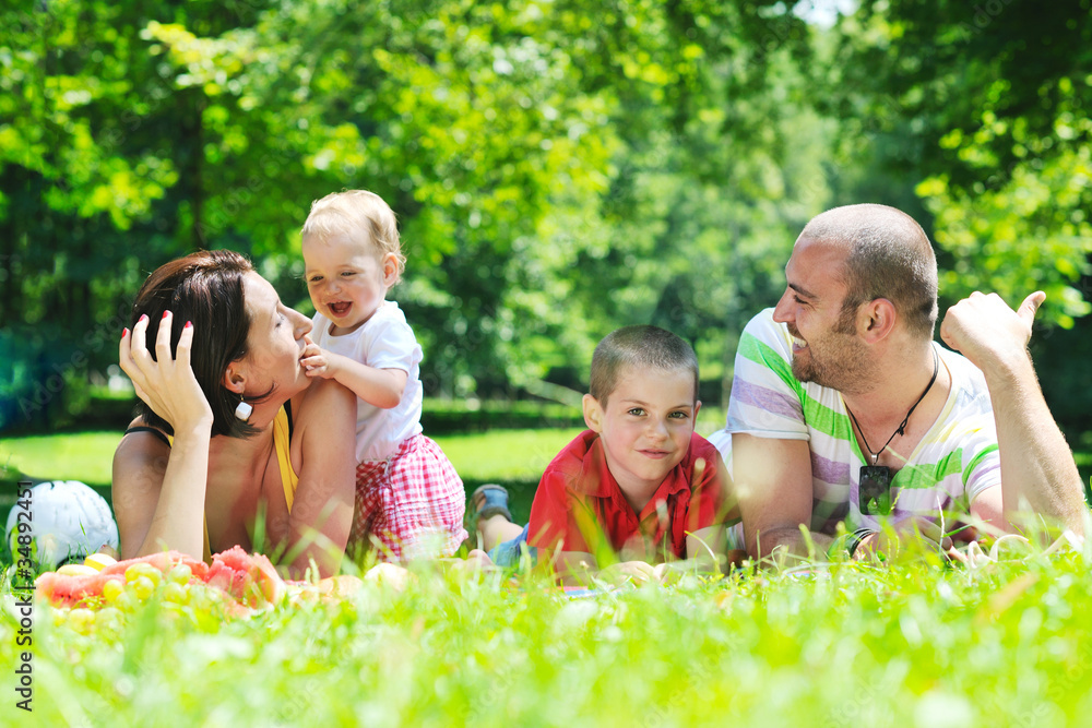Fototapeta premium happy young couple with their children have fun at park