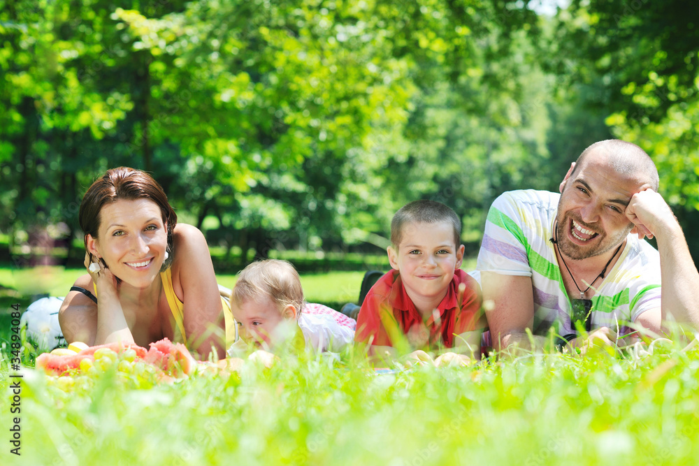 happy young couple with their children have fun at park happy young couple with their children have fun at park