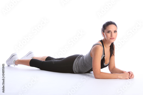 Beautiful athletic woman in sports outfit on floor