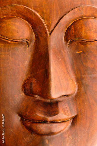 Face of Lord Buddha made ​​of wood.