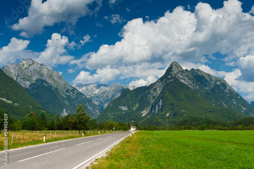 Idyllic mountain valley with road and meadow. Slovenia