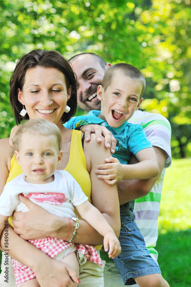 happy young couple with their children have fun at park happy young couple with their children have fun at park