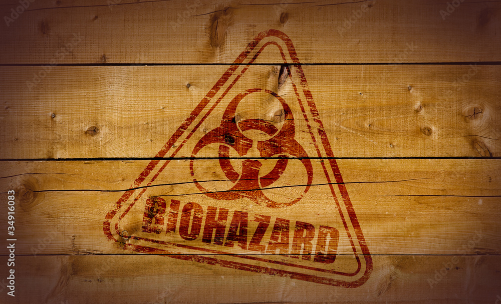 Naklejka premium Biohazard stamp on wooden background