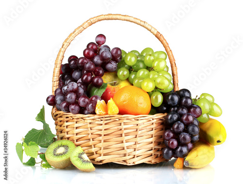 Ripe juicy fruits in  basket isolated on white