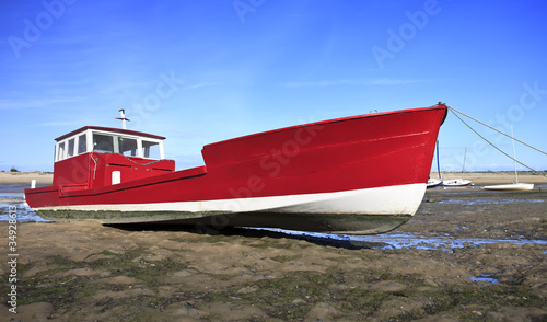 Red boat at low tide in Lege Cap Ferret, France photo