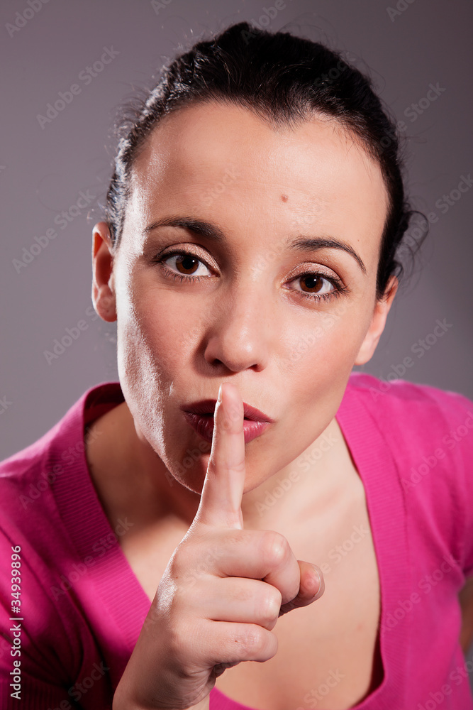 Young woman asking for silence. Studio shot Young woman asking for silence. Studio shot