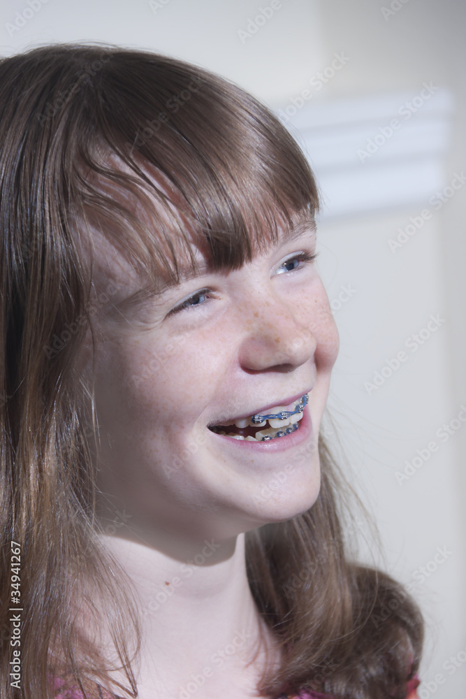 A smiling preteen girl with braces A smiling preteen girl with braces