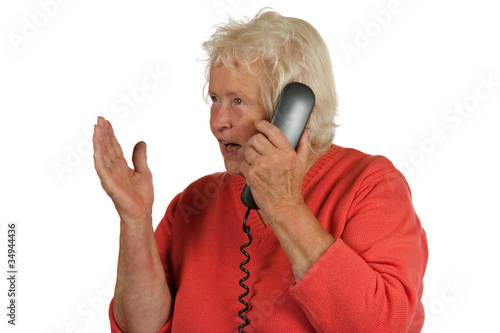 Senior woman is discussing while telephoning photo