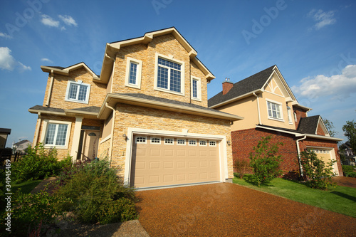 Two new two-storied beige stone and brick cottage with garage © Pavel Losevsky