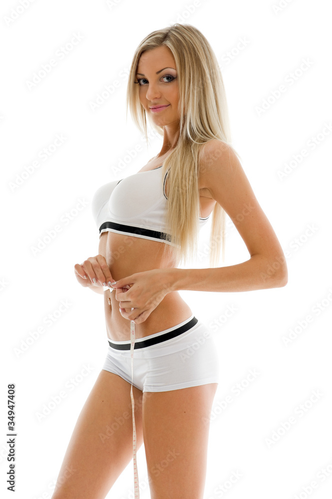 Obraz premium Beautiful blonde is measuring her waist