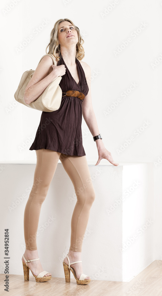 standing woman wearing summer clothes and shoes with a handbag standing woman wearing summer clothes and shoes with a handbag