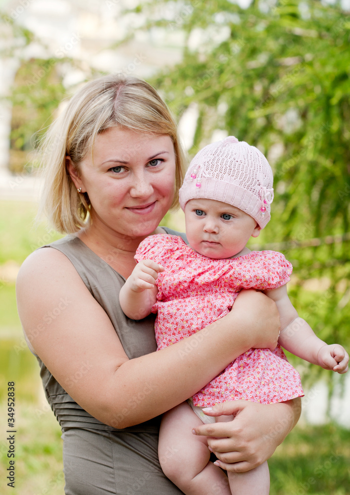 Young mum walks with the child in city park Young mum walks with the child in city park