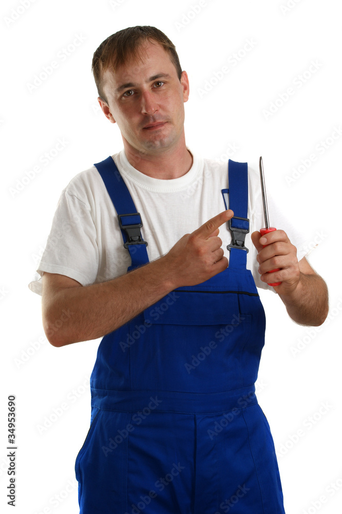 Handwerker mit blauer Latzhose hält einen Schraubenzieher Handwerker mit blauer Latzhose hält einen Schraubenzieher