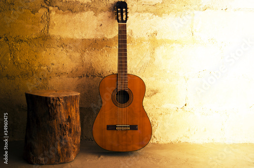 Acoustic guitar on old wall - copyspace