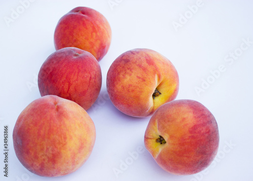 Ripe, juicy peaches isolated on white background