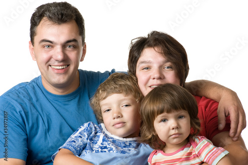 Casual portrait of a young family on white
