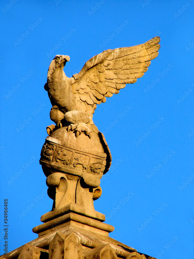 sculpture of  eagle on  sphere with zodiac signs in barcelona. s