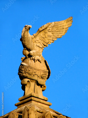 sculpture of eagle on sphere with zodiac signs in barcelona. s