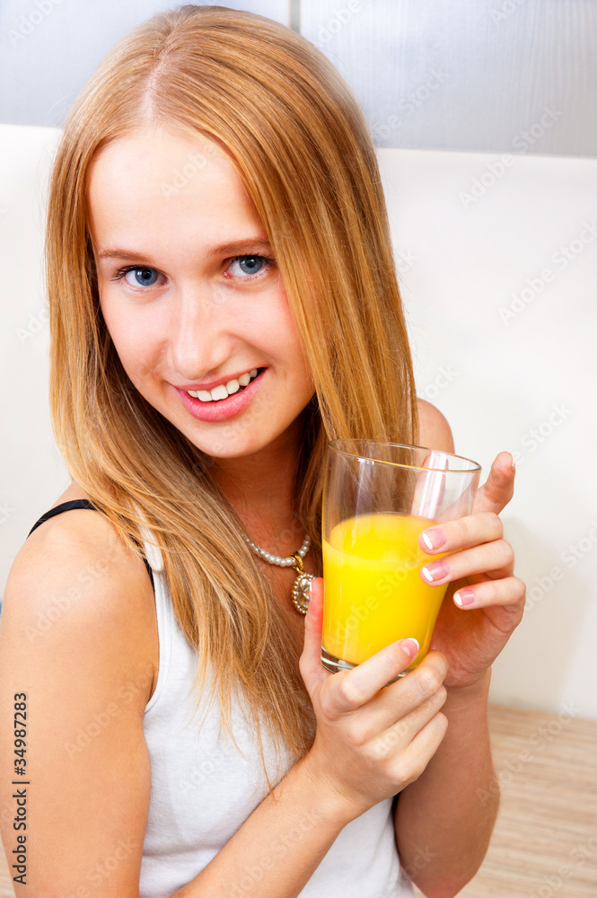 Portrait of beautiful relaxed young woman standing at the kitche Portrait of beautiful relaxed young woman standing at the kitche
