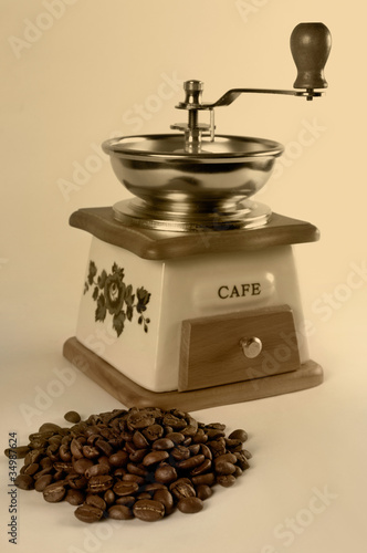 Coffee Grinder and a Pile of Coffee Beans